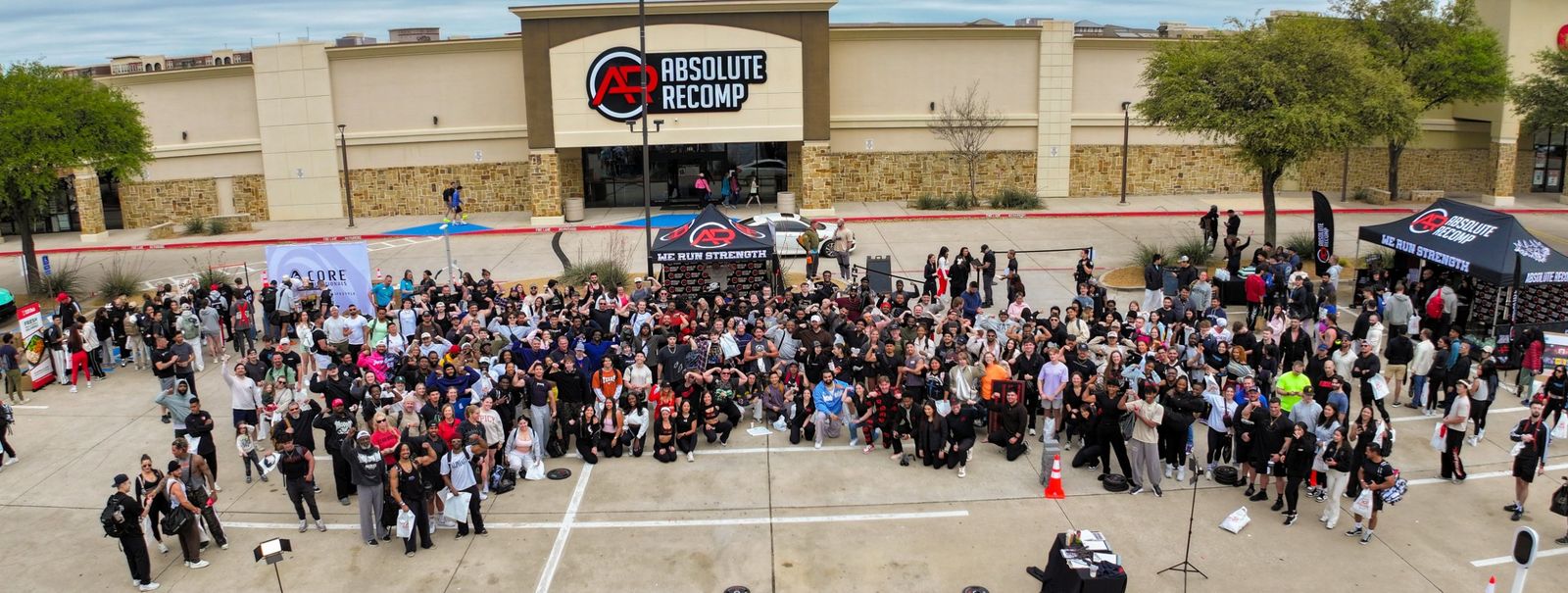 A large crowd gathered outside Absolute Recomp gym for a member appreciation event.